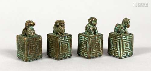 A SET OF FOUR CHINESE BRONZE SEALS. 1.5ins high.