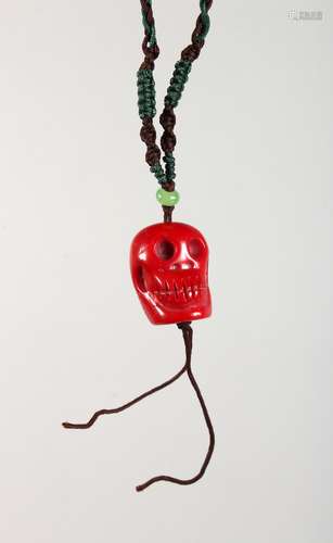 A CHINESE CORAL CARVED SKULL PENDANT. 1ins high.