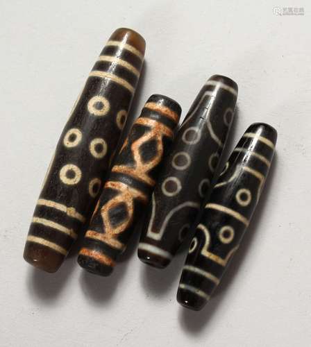 FOUR TIBETAN AGATE BEADS. 2.25ins and 3ins long.