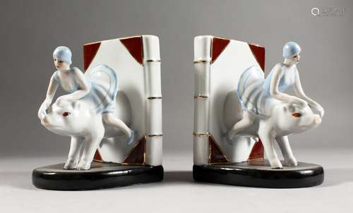 A PAIR OF ART DECO DESIGN BOOKENDS, lady riding a pig. 6ins high.