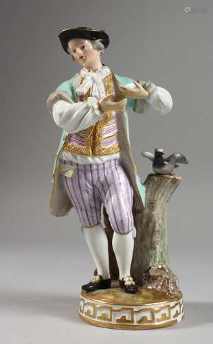 A MEISSEN PORCELAIN FIGURE OF A YOUNG MAN standing beside a tree stump with a bird. Cross swords