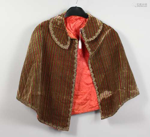 A GREEN AND MAROON STRIPED VELVET CAPE; together with a Regency style waistcoat.