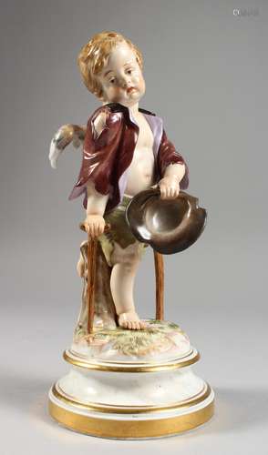 A MEISSEN PORCELAIN FIGURE OF A CHERUB holding a hat and walking with a stick. Cross swords mark