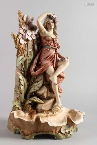 A ROYAL DUX PORCELAIN VASE, depicting a young lady seated by a wall with flowers and a shell