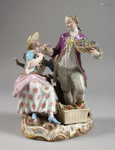 A GOOD MEISSEN PORCELAIN GROUP OF A GALLANT AND LADY, the man standing with a basket of flowers, the