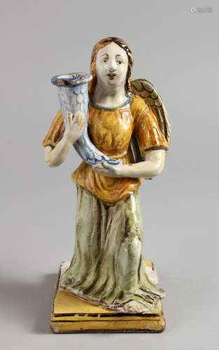 AN 18TH/19TH CENTURY ITALIAN MAIOLICA CANDLESTICK, modelled as a kneeling angel holding a cornucopia