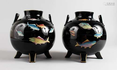 A PAIR OF ARTS & CRAFTS GLOBULAR SHAPED TERRACOTTA VASES, black glazed, painted with fish. 8ins