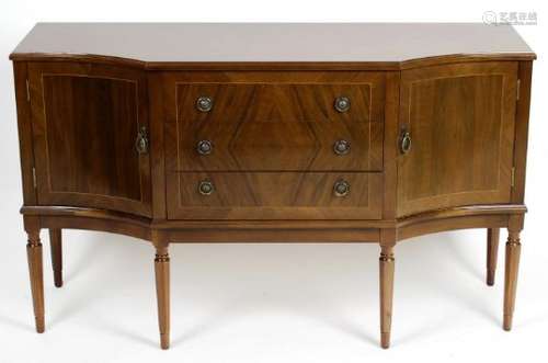 A reproduction mahogany veneered extending dining room table,