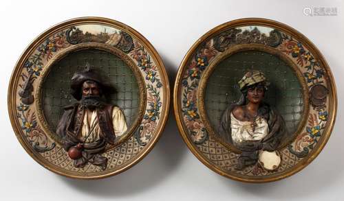 A PAIR OF LATE 19TH CENTURY CONTINENTAL POTTERY CHARGERS, moulded decoration with the bust of a