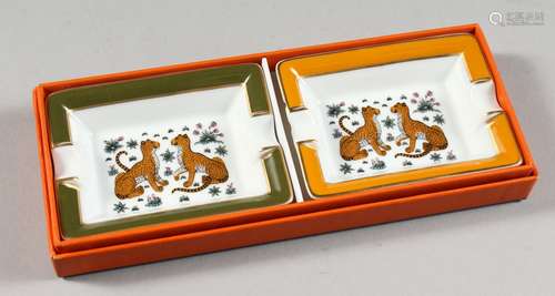 A PAIR OF HERMES PORCELAIN ASHTRAYS, decorated with leopards, in a Hermes box.