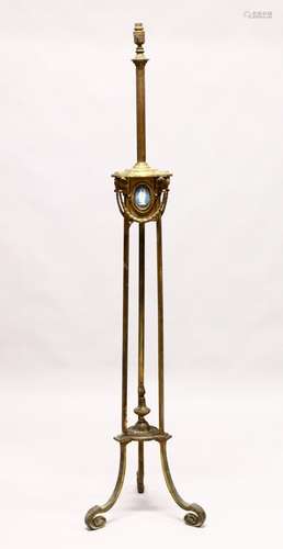 AN EMPIRE METAL STANDING LAMP, inset with three Wedgwood plaques, on triple curving legs. 5ft 4ins