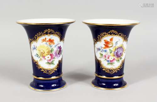 A GOOD PAIR OF MEISSEN PORCELAIN BLUE GROUND TRUMPET VASES, edged in gilt and painted with a panel