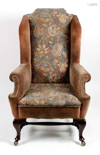 A wing back armchair with pink draylon and tapestry panel back,