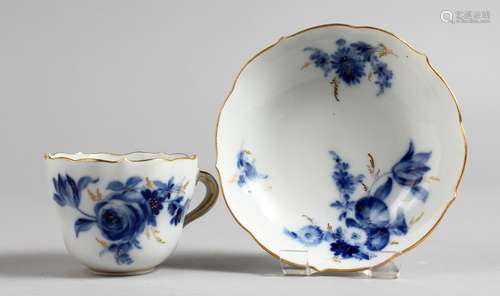 A SMALL MEISSEN CUP AND SAUCER, painted in blue and gilt with sprays of flowers. Saucer: 4ins