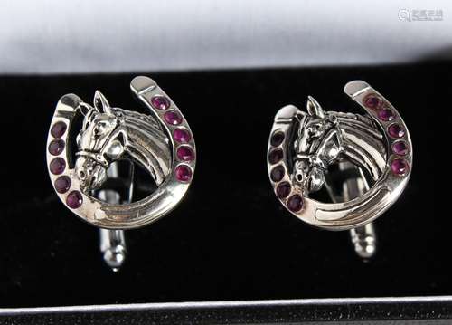 A PAIR OF SILVER RUBY SET HORSESHOE CUFFLINKS.