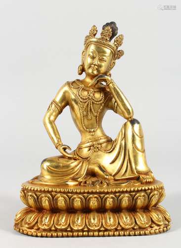 A CHINESE GILT BRONZE FIGURE OF A SEATED DEITY. 8ins high.