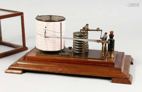 A BAROGRAPH in a glass case.