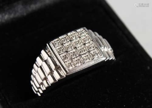 A GENTLEMAN'S SILVER DIAMOND SET RING.