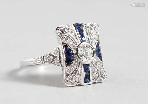 A SILVER DECO DESIGN FAUX SAPPHIRE RING.