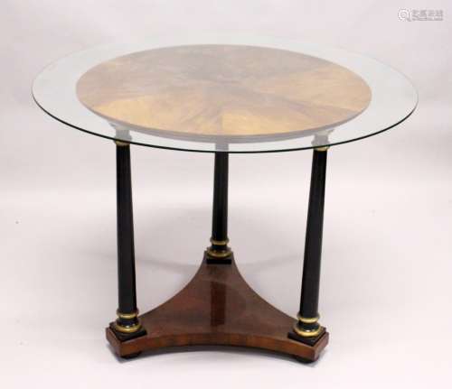 AN EMPIRE REVIVAL CIRCULAR MAHOGANY CENTRE TABLE, with three ebonised turned column supports on a