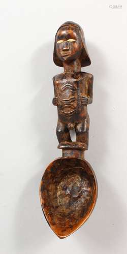 A TRIBAL FIGURAL SPOON. 10ins long.