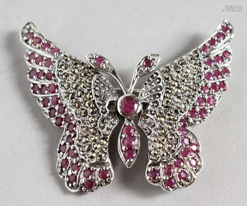 A SILVER PLIQUE RUBY SET BUTTERFLY BROOCH.