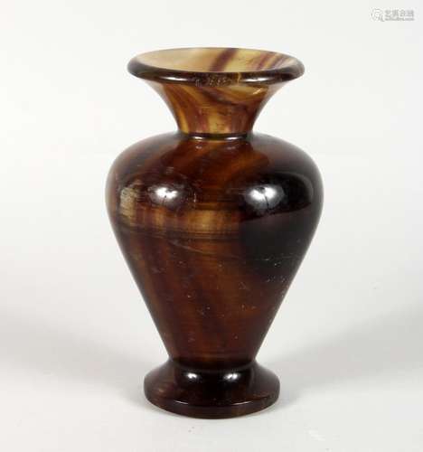 A STONE BALUSTER-SHAPED VASE. 8ins high.