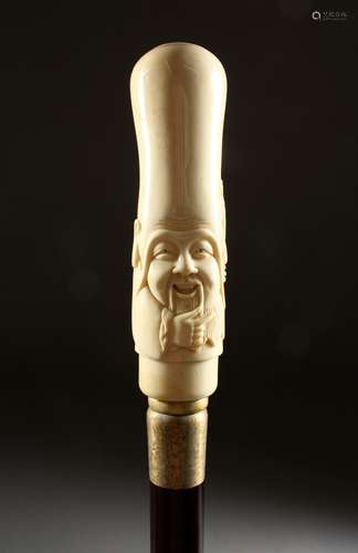 A BONE HANDLED WALKING STICK, carved as a Chinese man. 37ins long.