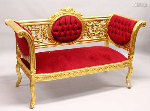 A LOUIS XVI STYLE GILT FRAMED SETTEE, with crimson upholstery. 5ft 1ins long.