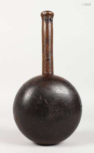 A VERY HEAVY EARLY LIGNUM BULBOUS MALLET, with ash handle. 5.5ins diameter.