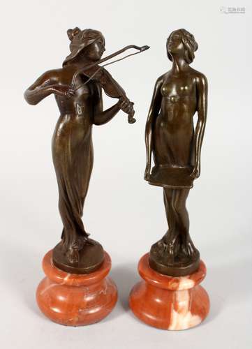 A PAIR OF BRONZE ART NOUVEAU LADIES on onyx bases. 8ins high.