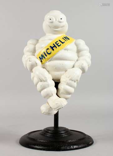 A PAINTED CAST IRON MICHELIN MAN, on a stand.