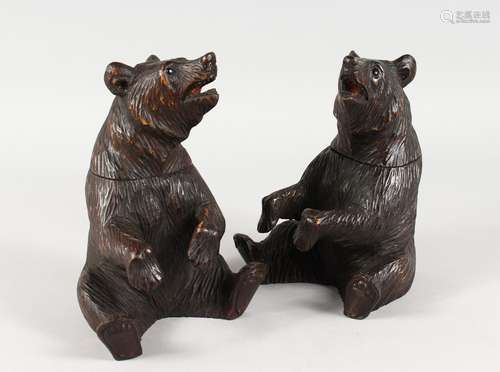 A GOOD PAIR OF BLACK FOREST CARVED WOOD SEATED BEAR TOBACCO JARS AND COVERS. 8ins high