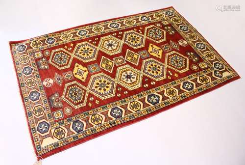 A MODERN PERSIAN RUG, rust ground with two rows of five large medallions. 6ft 3ins x 3ft 11ins.