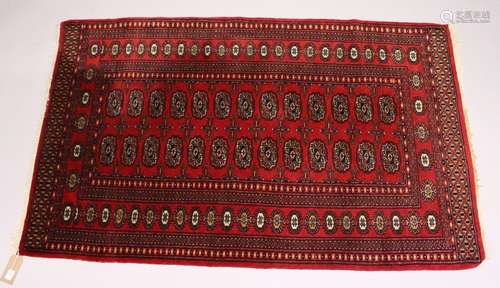 A MODERN BOKHARA STYLE RUG, red ground with two rows of thirteen gulls. 5ft 1ins x 3ft 2ins.