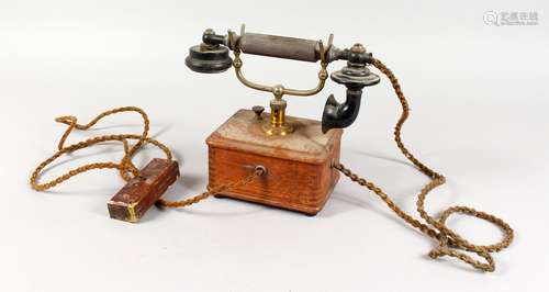 A VINTAGE ERICSSON TELEPHONE, with Bakelite handle, brass stand and wooden base.