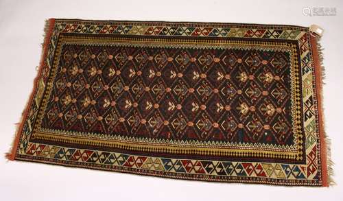 A PERSIAN CAUCASIAN RUG, EARLY 20TH CENTURY, black ground with five rows of gulls, within a beige