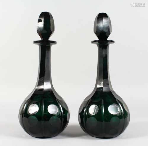 A GOOD PAIR OF GREEN CUT GLASS DECANTERS AND STOPPERS. 14ins high.