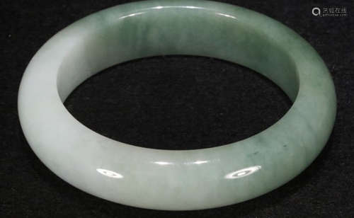 A JADEITE CARVED BANGLE