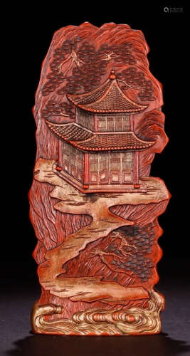 A CINNABAR ORNAMENT CARVED WITH LANDSCAPE