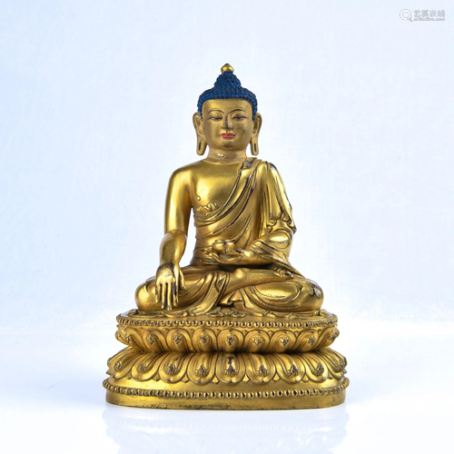 A GILT-BRONZE FIGURE OF SAKYAMUNI.MING PERIOD