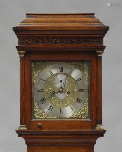 An 18th century oak longcase clock with eight day movement striking on a bell, the 12-inch square