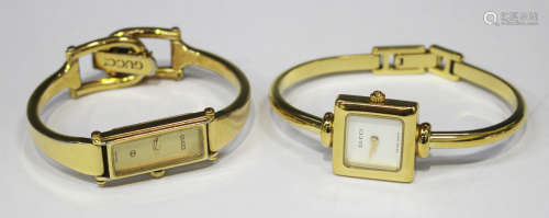 A Gucci lady's gilt bangle wristwatch with square dial, the case back detailed 'Gucci 1900 L',