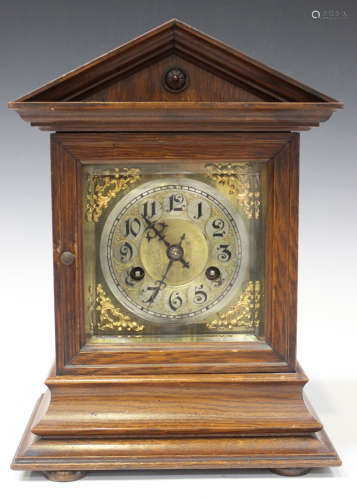 A late 19th century German oak mantel clock, the Junghans movement striking hours and half hours