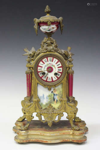 A late 19th century French spelter and porcelain mantel clock with eight day movement striking on