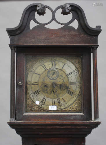 An 18th century oak longcase clock with eight day movement striking on a bell, the 12-inch square