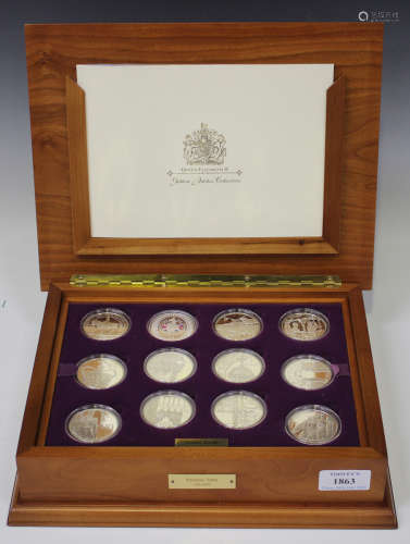 A collection of twenty-four silver and gilt proof crown-size collector's coins, commemorating the
