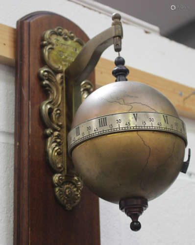 A Thwaites & Reed limited edition gravity timepiece, circa 1972, the suspended brass globe with