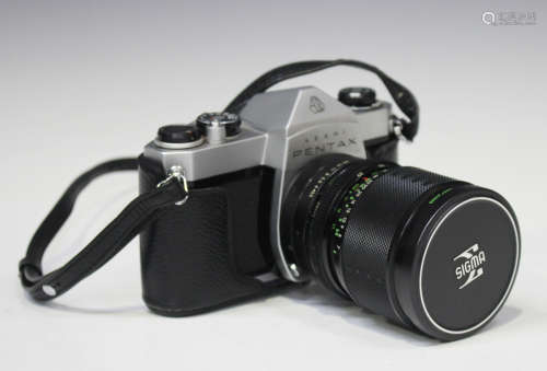 A collection of Pentax cameras and related accessories, including an SP500 camera with Sigma-XQ 1: