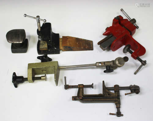 A large collection of vintage watchmakers' tools and accessories, including various staking tool